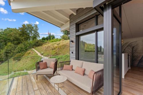 a patio with a couch and chairs on a deck at Lodge Glardons in Marin