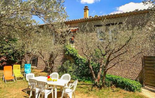 une table et des chaises devant un bâtiment en briques dans l'établissement Stunning Home In Vaison La Romaine, à Vaison-la-Romaine
