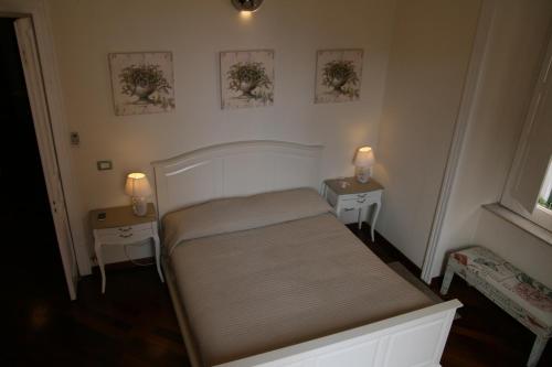 a small bedroom with a bed and two tables at B&B Mini Hotel Incity-close train station and port- in Salerno