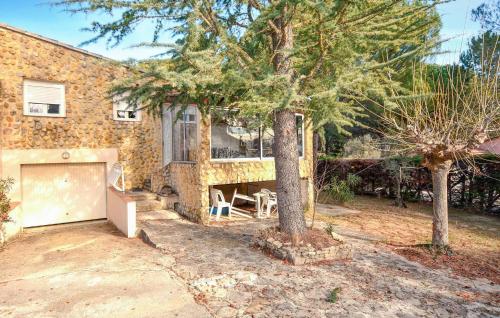 une maison en briques avec un garage et un arbre dans l'établissement Gorgeous Home In Vaison-La-Romaine, à Vaison-la-Romaine