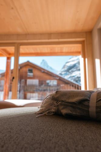 a blanket laying on the floor in front of a window at Rofel Zermatt in Zermatt