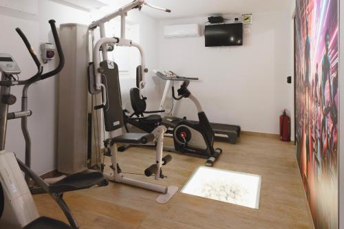 a gym with several exercise bikes in a room at Residence i Tigli in Cinisello Balsamo