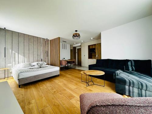 a living room with a couch and a table at Willa ROXY Jastrzębia Góra in Jastrzębia Góra
