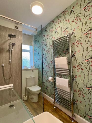 a bathroom with a shower and a toilet and a sink at The Stags Head Apartment in Inverness