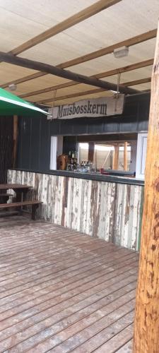 a room with a wooden floor and a sign that reads misbushenstein at Meeulekker op Lambertsbay in Lambertʼs Bay
