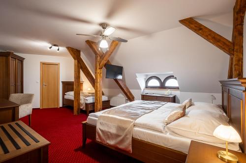 a bedroom with a large bed in a room with wooden beams at Smolenický zámok in Smolenice