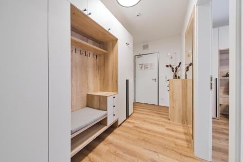 a hallway with white walls and wooden flooring at Bohemian Glow of Krumlov in Český Krumlov