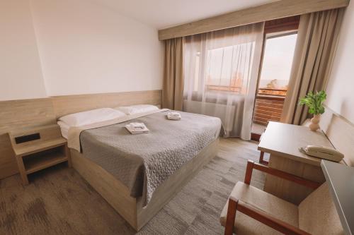 Postel nebo postele na pokoji v ubytování ATLAS Hotel Tatry