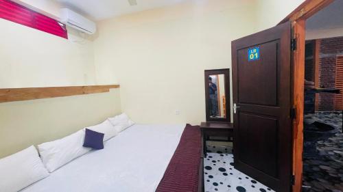 a small room with two beds and a door at Saa in Anuradhapura