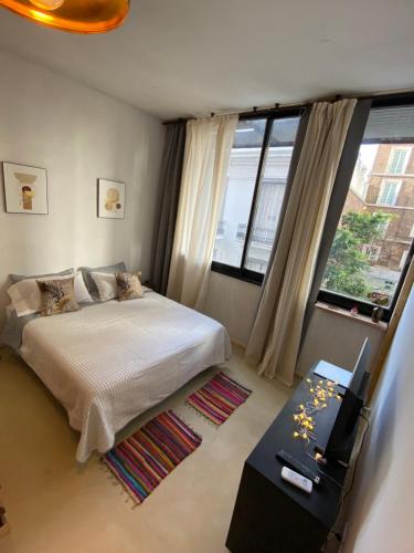 a bedroom with a bed and a large window at Tuc540 in Buenos Aires