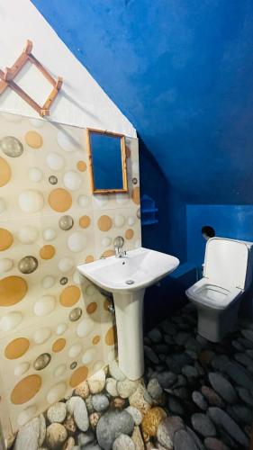 a bathroom with a sink and a toilet at Saa in Anuradhapura
