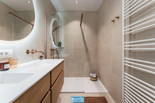 a bathroom with a sink and a shower at C-Mar - luxury accommodation in Nieuwpoort in Nieuwpoort