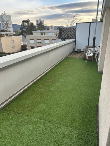 a balcony with green grass on a building at Аpartment with a large terrace in Reinach