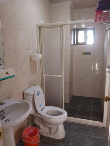 a bathroom with a toilet and a sink and a shower at Kinmen 988 Homestay in Jincheng