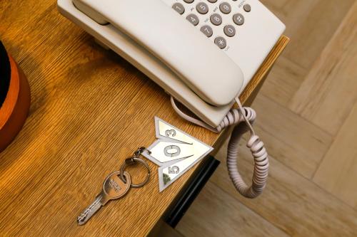 a phone sitting on top of a table with keys at Rixoss Tower Pyramids View in Cairo