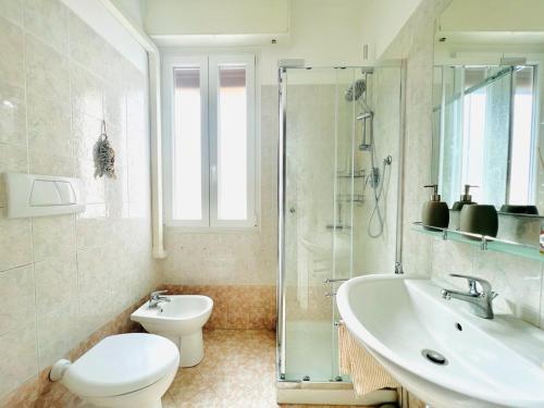 a bathroom with a toilet and a sink and a shower at Sally's - Nel cuore di Sanremo in Sanremo