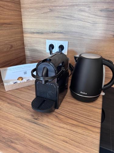 a black coffee maker sitting on a table at Vista Izera in Świeradów-Zdrój