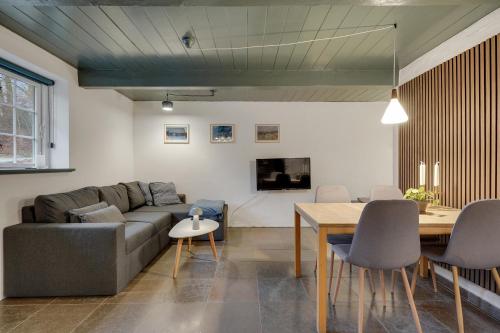 a living room with a couch and a table at Hørhavegården B&B in Højbjerg