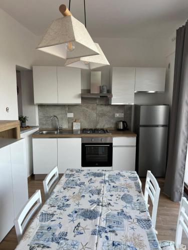 a kitchen with a table with a blue and white pattern at Villetta Zuccale 6 in Capoliveri
