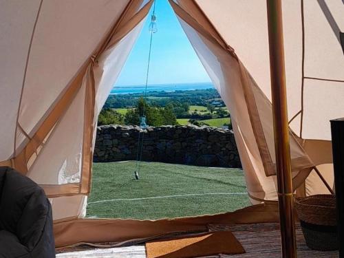 a view of a soccer field from inside a tent at Fairy Fort at Rosemount Glamping in Carlingford