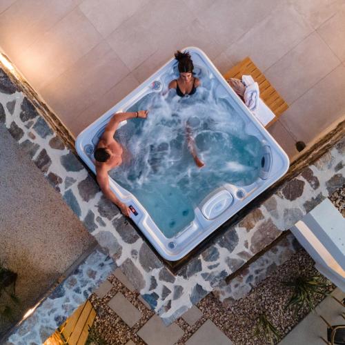 a man in a bath tub in a swimming pool at Villa Anamnisis in Naxos Chora