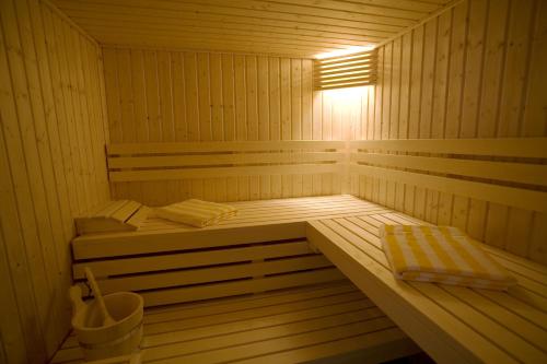 a sauna with two beds and a light in it at Hôtel La Rivière in Entraygues-sur-Truyère