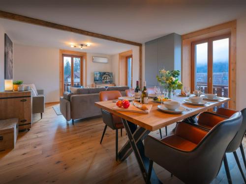 une salle à manger et un salon avec une table et des chaises dans l'établissement Tigerlily - OVO Network, à Samoëns
