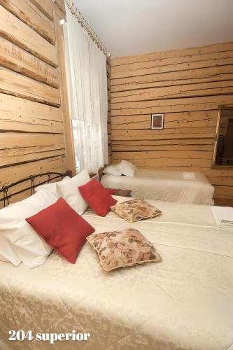 a bedroom with two beds with red pillows on them at Guesthouse Carl Schmidt in Põltsamaa
