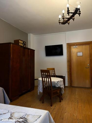 a bedroom with a bed and a chair and a dresser at Guesthouse Carl Schmidt in Põltsamaa