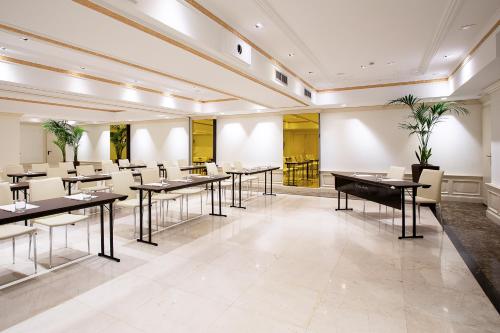 a restaurant with tables and chairs in a room at Hotel Fenix Gran Meliá - The Leading Hotels of the World in Madrid