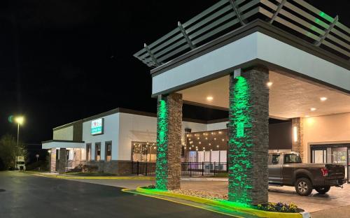 a gas station at night with green lights at Holiday Inn Roanoke - Tanglewood Route 419 & I 581 by IHG in Roanoke