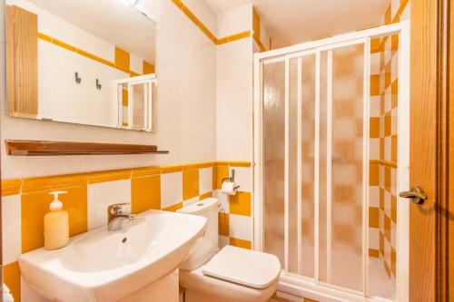 a bathroom with a sink and a toilet and a shower at Cal Emilia in Ossó de Sió
