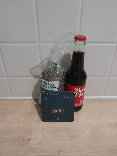 a bottle of beer sitting next to a bag of cocaine and a box ofrax at Charmant Studio l'Arnon à Issoudun in Issoudun