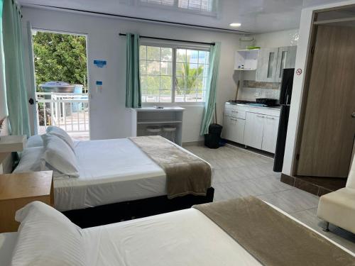 a hotel room with two beds and a kitchen at SWEET BREEZE in San Andrés