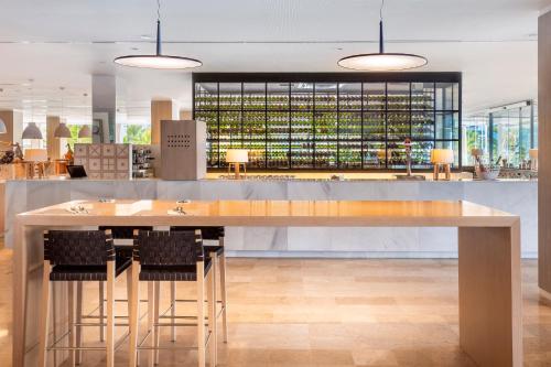 a large counter with chairs and a bar in a restaurant at Meliá Calviá Beach in Magaluf
