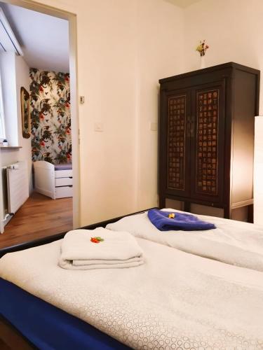 a bedroom with two beds with towels on them at KB CityRooms Self-Check-In in Luzern