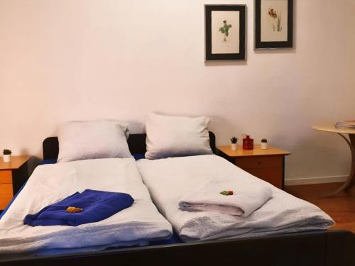 two beds in a room with towels on them at KB CityRooms Self-Check-In in Luzern