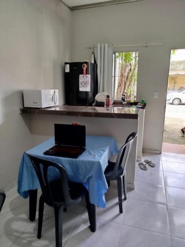 a kitchen with a table with a laptop on it at Flat em são Brás COP30 in Belém