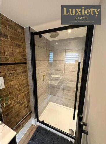 a shower with a glass door in a bathroom at 2BR Flat By Luxiety Stays Short Lets & Serviced Accommodation Southend on sea With Free WiFi & Netflix in Southend-on-Sea