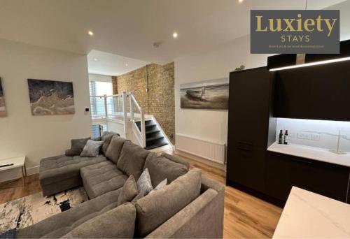 a living room with a couch and a tv at 2BR Flat By Luxiety Stays Short Lets & Serviced Accommodation Southend on sea With Free WiFi & Netflix in Southend-on-Sea