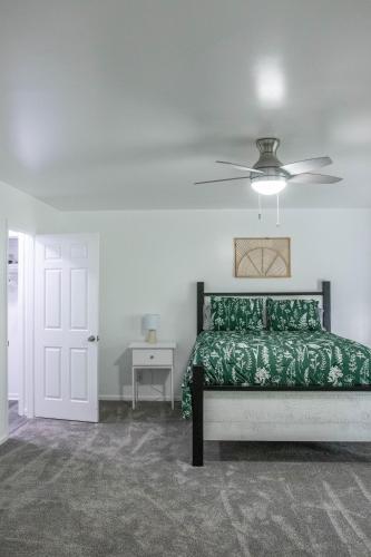 a bedroom with a bed and a ceiling fan at Hunter's Cove in Morehead
