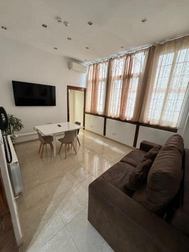 a living room with a couch and a table at Apartamentos Apolo in Madrid