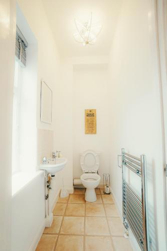 a bathroom with a toilet and a sink at 'Hidden Jewel' city centre + FREE PARKING in Plymouth