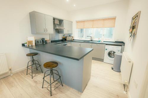a kitchen with a counter and a sink and a dishwasher at 'Hidden Jewel' city centre + FREE PARKING in Plymouth