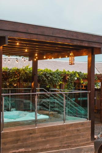 a building with a deck with lights on it at Lukinhas Pousada in Nobres