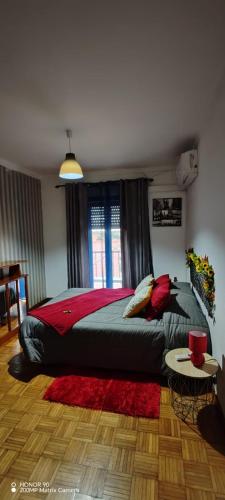 a bedroom with a large bed with a red blanket at Apartamento Fazunchar in Figueiró dos Vinhos