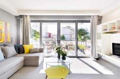 a living room with a couch and a table at Stylish Boutique Loft With Private Balcony in Athens
