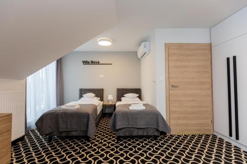 a room with two beds and a hallway with a door at Villa Nova in Białystok