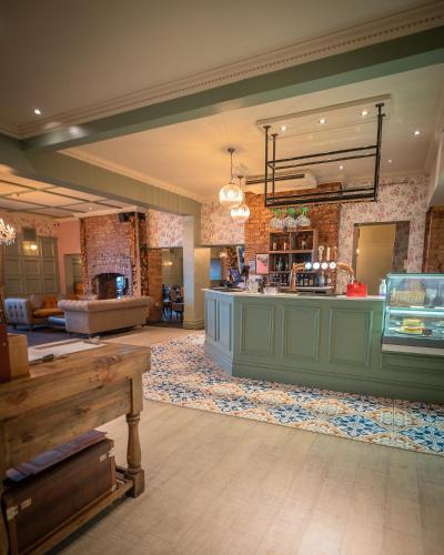 a large lobby with a counter in a room at Roker Hotel BW Premier Collection in Sunderland