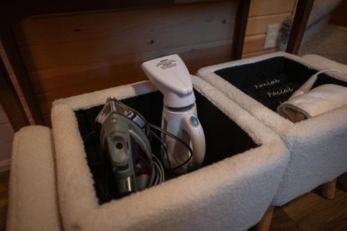 a box with a hairdryer and other items in it at Timber Haven Aframe Cabin - Brand New Hot Tub in Friendship
